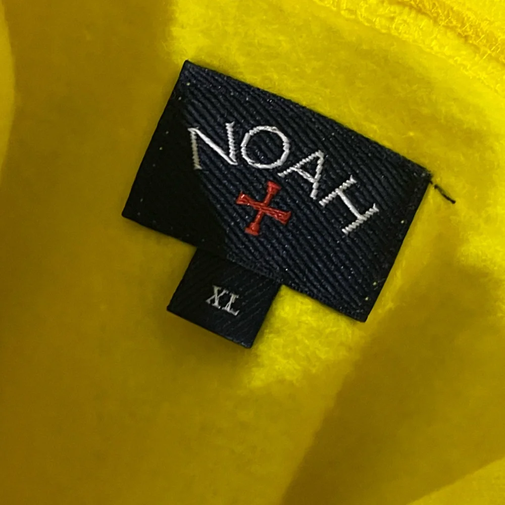 Noah NYC Yellow Hoodie with Black Logo and Red Cross - Picture 2 of 3